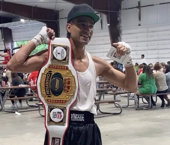 BoxFit Utah fighter holding a championship belt
